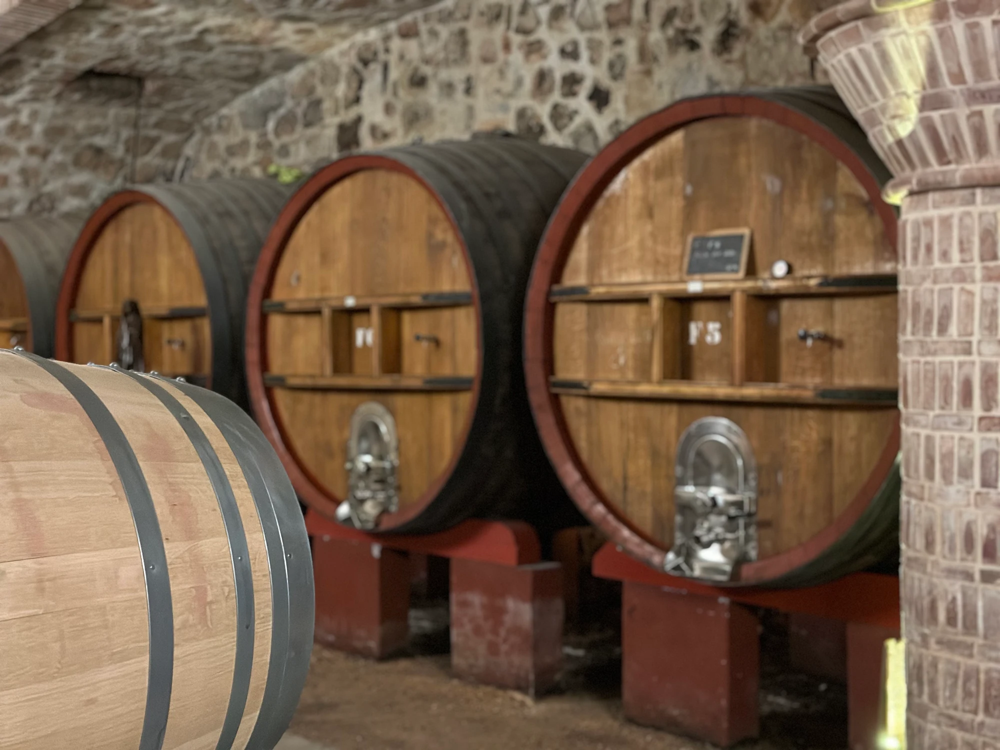 Large wooden casks in the cellars at Château Rasque